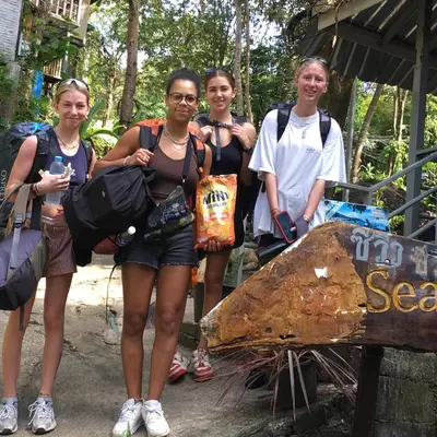 a group of people standing next to a sign at Sea View Bungalow in Phi Phi Don