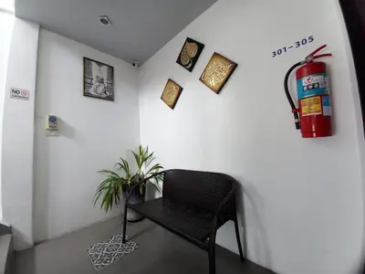 a black chair in a room with a fire hydrant at In Phuket House in Phuket Town
