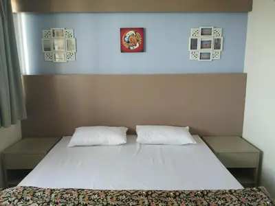 a bedroom with a bed with two pillows on it at In Phuket House in Phuket Town