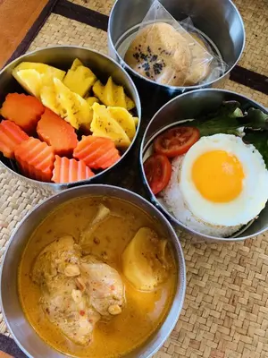 a group of four bowls of food with eggs and vegetables at Lantala Residence in Natai Beach