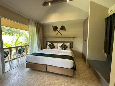a bedroom with a large bed and a balcony at Sakoo Valley Naithon Beach in Nai Thon Beach