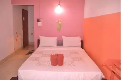 a bedroom with a bed with two pairs of shoes on it at Sweet Home Patong in Patong Beach