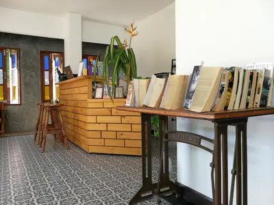 a table with books sitting on top of it at The Umbrella House in Kamala Beach