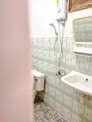 a bathroom with a toilet and a sink at Lux Guesthouse in Phi Phi Don