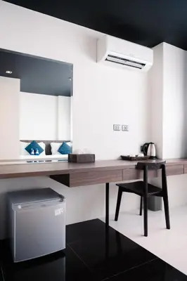 a kitchen with a wooden desk and a mirror at BearPacker Patong Hostel in Patong Beach