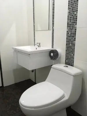 a bathroom with a white toilet and a sink at Phuket Best Travel in Nai Yang Beach