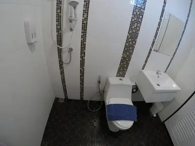 a bathroom with a shower and a toilet and a sink at Phuket Best Travel in Nai Yang Beach