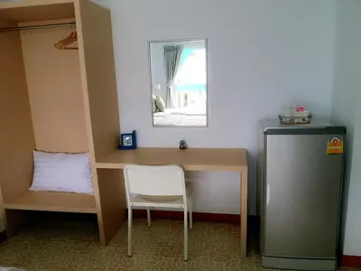 a desk with a chair and a mirror in a room at The Duck in Phuket Town