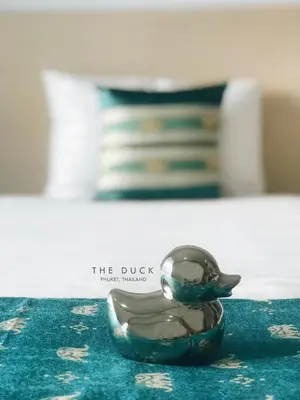 a small bird figurine sitting on top of a table at The Duck in Phuket Town