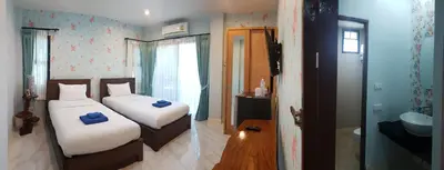 a bedroom with two beds and a bathroom at Krabi Lighthouse @ Aonang in Ao Nang Beach