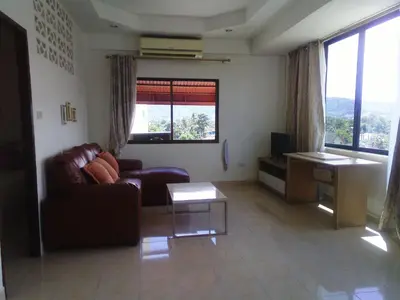 a living room with a couch and a table at Rawai Condotel 3 in Rawai Beach