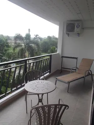 a balcony with a table and chairs and a chair at Coconoi Residence in Nai Harn Beach
