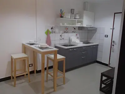 a small kitchen with a sink and a table at Coconoi Residence in Nai Harn Beach