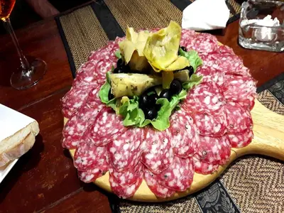 a plate of food with meat and vegetables on a table at Casa E Mare in Kata Beach