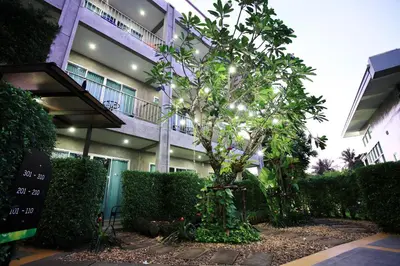 a building with a tree in front of it at The Malika Hotel - SHA Extra Plus in Phuket Town