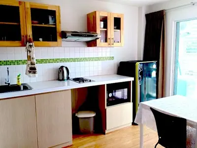 a kitchen with a sink and a refrigerator at Risa Plus in Kathu
