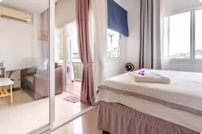 a bedroom with a bed and a sliding glass door at Phuket naka condon-52-25 \u6cf3\u6c60\u9ad8\u901f\u4e0a\u7f51\u514d\u8d39\u505c\u8f66 in Phuket Town