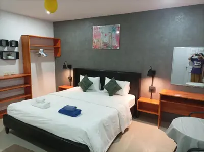 a bedroom with a bed with a blue towel on it at Bangtao Mango House in Bang Tao Beach