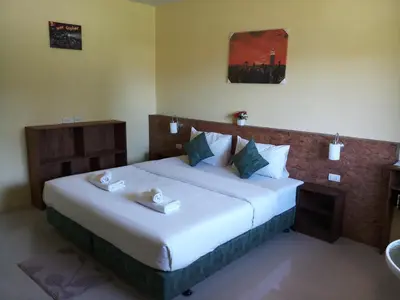 a bedroom with a large bed in a room at Bangtao Mango House in Bang Tao Beach