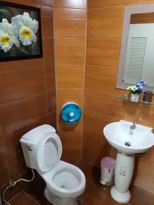 a bathroom with a toilet and a sink at 65 Pradit in Nai Yang Beach