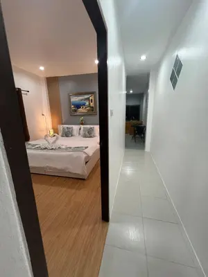 a bedroom with a bed in a room with a hallway at 65 Pradit in Nai Yang Beach