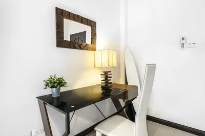 a desk in a room with a chair and a mirror at Champagne Villa by G Estate in Rawai Beach