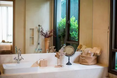 a bathroom counter with a sink and a mirror at Baan Mai Khao in Mai Khao Beach