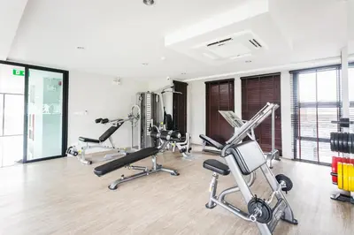 a gym with several exercise bikes in a room at 6th Avenue Surin by Lofty in Surin Beach