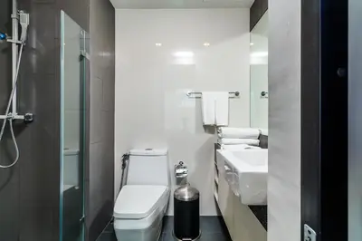 a bathroom with a toilet and a sink and a shower at 6th Avenue Surin by Lofty in Surin Beach