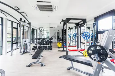 a gym with lots of treadmills and machines at 6th Avenue Surin by Lofty in Surin Beach