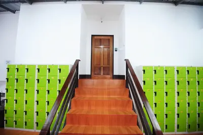 a stairway with green boxes and a wooden door at Twin Palms Hostel Phi Phi in Phi Phi Don