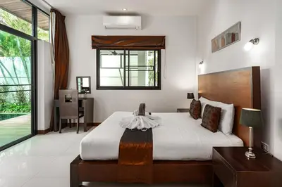 a bedroom with a bed and a desk and a window at Emotion 2 Villa by G Estate in Rawai Beach