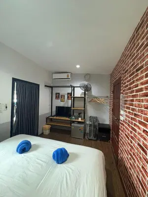 a bedroom with a bed with blue pillows on it at Krabi Nemo House in Ao Nang Beach