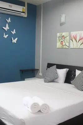 a bedroom with a bed with two towels on it at Krabi Nemo House in Ao Nang Beach