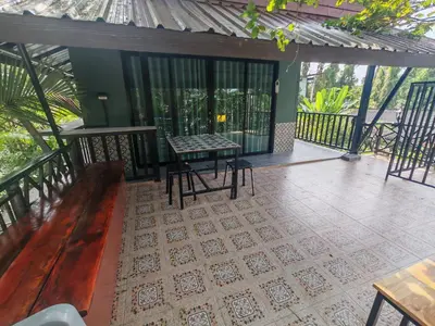 a patio with a table and chairs on a deck at Nemo 2 Resort in Ao Nang Beach