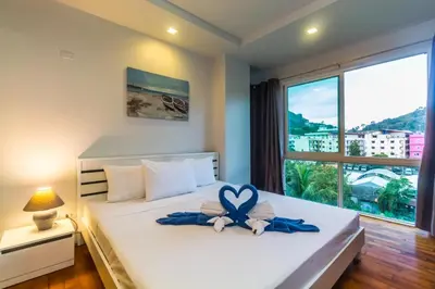 a bedroom with a bed with a heart decoration on it at Heaven Lagoon Condo by Lofty in Patong Beach
