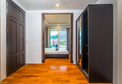 a hallway with two doors leading to a bedroom at Heaven Lagoon Condo by Lofty in Patong Beach