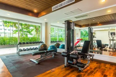 an empty gym with several treadmills and weights at Heaven Lagoon Condo by Lofty in Patong Beach