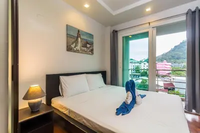 a bedroom with a bed and a window at Heaven Lagoon Condo by Lofty in Patong Beach