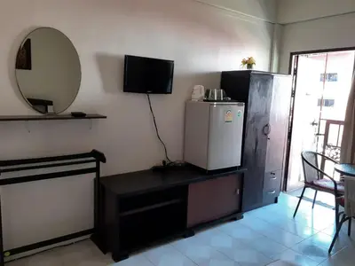 a living room with a refrigerator and a mirror at NB House in Karon Beach