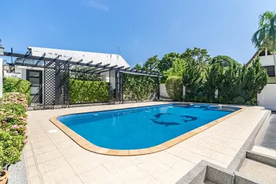 a swimming pool in the backyard of a house at Villa Andre by VillaCarte in Nai Harn Beach