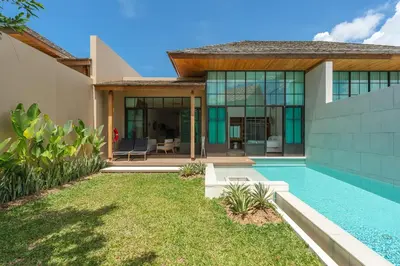 a villa with a swimming pool and a house at Saturdays Residence by Brown Starling in Rawai Beach