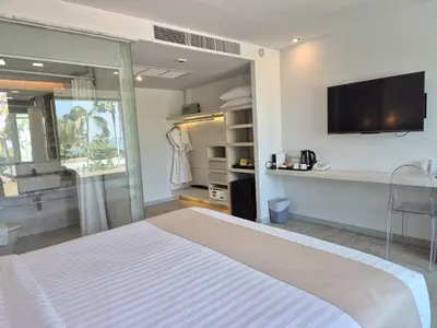 a bedroom with a bed and a tv on the wall at The Bloc Hotel Phuket in Patong Beach