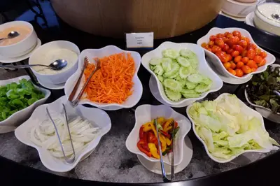 a bunch of vegetables in bowls on a table at AVA SEA Resort Krabi, Ao Nang Beach in Ao Nang Beach