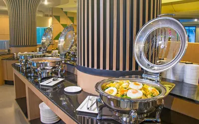 a buffet line with egg dishes in a restaurant at AVA SEA Resort Krabi, Ao Nang Beach in Ao Nang Beach
