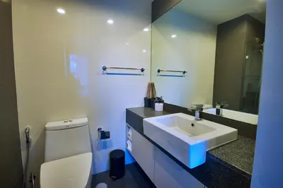 a bathroom with a white sink and a mirror at 6th Avenue Surin by Risa in Surin Beach