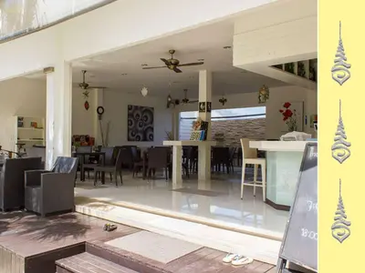 a living room and dining room with a table and chairs at Apt S104 Kamala Regent in Kamala Beach