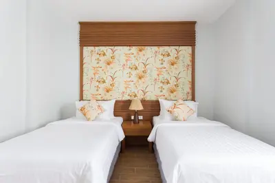 two beds in a room with white walls at Alisea Pool Villa Aonang in Ao Nang Beach