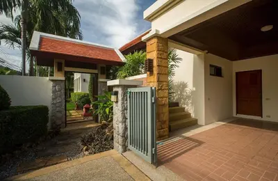 a house with a gate in front of it at VILLA PAGAI Pool Baan Bua Estate Naiharn in Rawai Beach