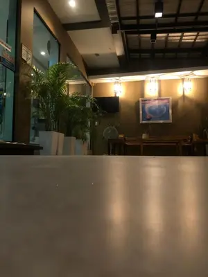 a table in a restaurant with lights on the wall at S2 Residence in Ao Nang Beach